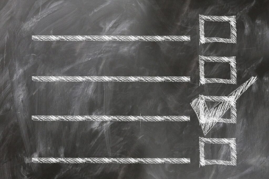 A chalkboard checklist with horizontal lines and a single box marked with a check.