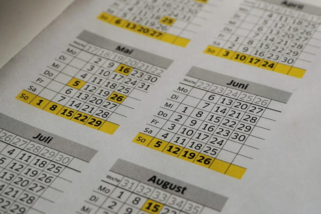 A close-up of a calendar page with several dates highlighted in bright yellow.